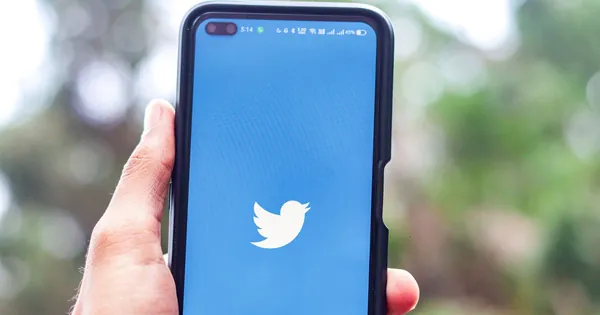 Twitter app opening on a smartphone held outdoors